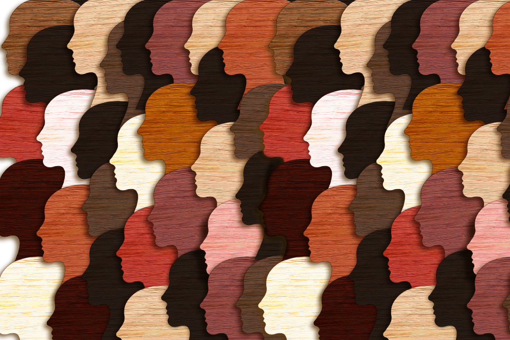 Graphic of many women's heads in profile in different shades of brown and cream.