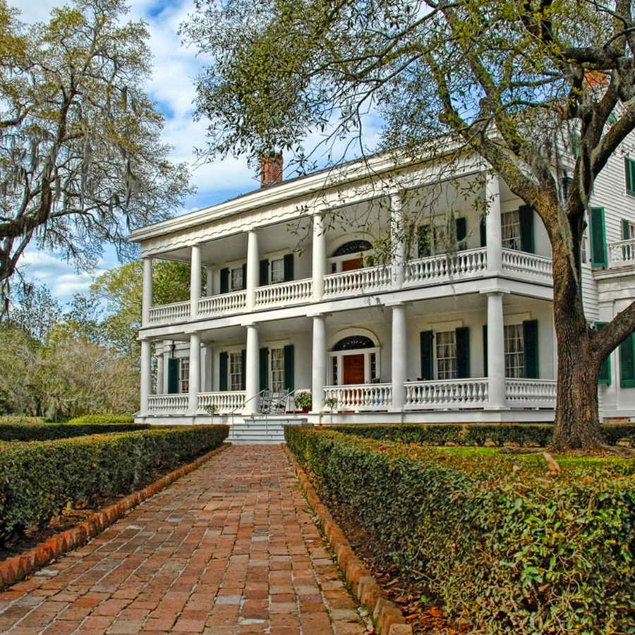Two Story White Plantation House with upper and lower verandas