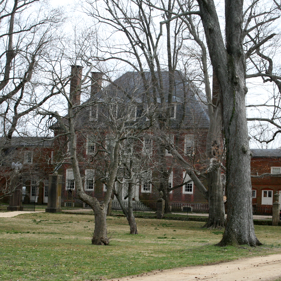 3 story red brick plantation house with tall hip roof