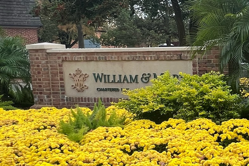 William and Mary brick sign with yellow flowers in front