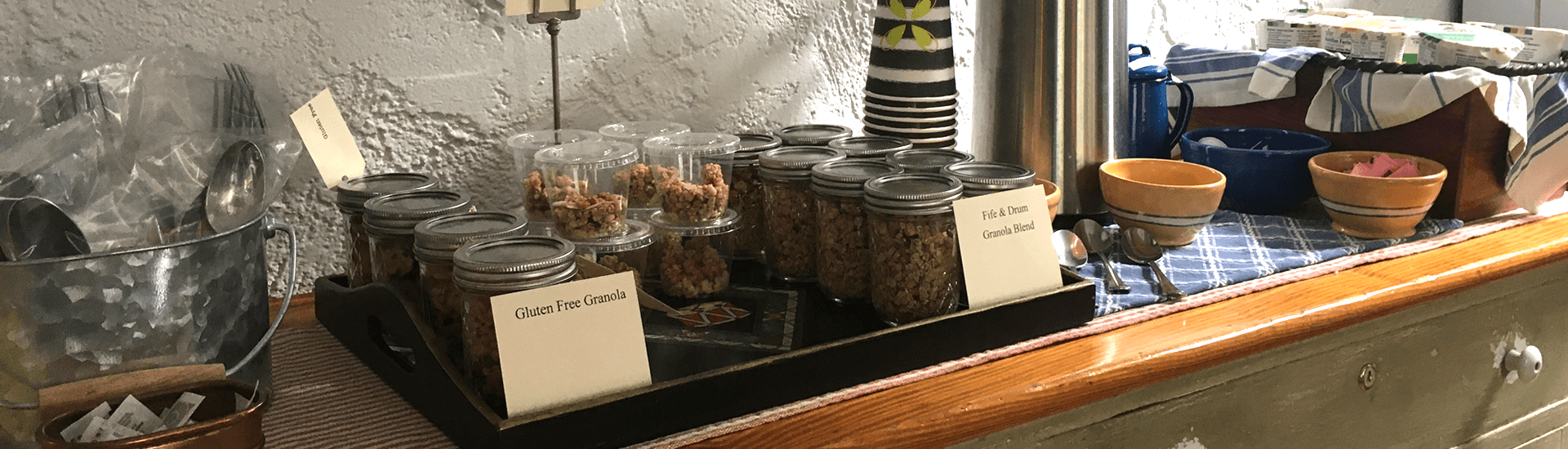 Breakfast buffet with granola, bowls and blue cloth