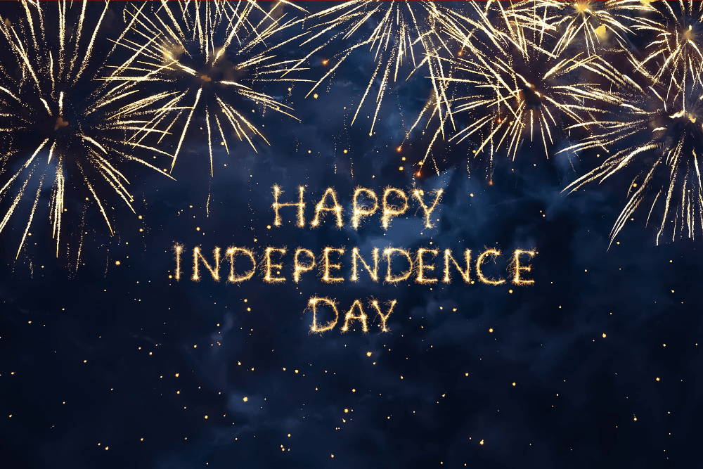 Fireworks and signage spelling out happy 4th of july