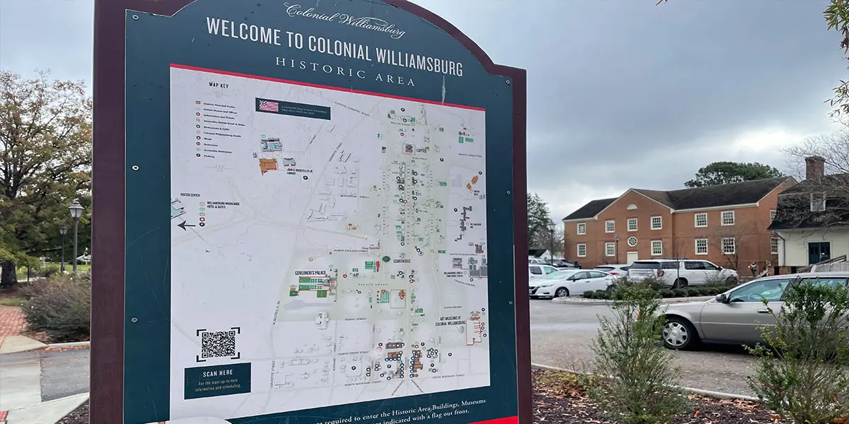 Signage map of Colonial Williamsburg's historic area with surrounding buildings and parking.