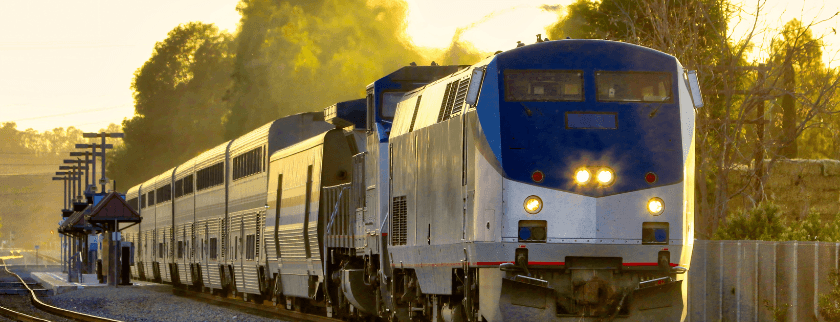 A train approaches a station bathed in golden light. A train approaches a station bathed in golden light.